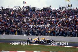 Nigel Mansell (GBR) Williams FW14B Renault 1st position passes team-mate Riccardo Patrese (ITA) 2nd position