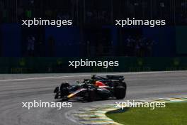 Sergio Perez (MEX) Red Bull Racing RB19 and Lewis Hamilton (GBR) Mercedes AMG F1 W14 battle for position. 05.11.2023. Formula 1 World Championship, Rd 21, Brazilian Grand Prix, Sao Paulo, Brazil, Race Day.