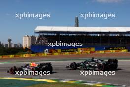 George Russell (GBR) Mercedes AMG F1 W14 and Sergio Perez (MEX) Red Bull Racing RB19. 05.11.2023. Formula 1 World Championship, Rd 21, Brazilian Grand Prix, Sao Paulo, Brazil, Race Day.