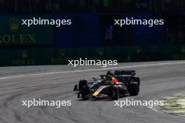 Sergio Perez (MEX) Red Bull Racing RB19 and Lewis Hamilton (GBR) Mercedes AMG F1 W14 battle for position. 05.11.2023. Formula 1 World Championship, Rd 21, Brazilian Grand Prix, Sao Paulo, Brazil, Race Day.