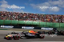 Sergio Perez (MEX) Red Bull Racing RB19 and Lewis Hamilton (GBR) Mercedes AMG F1 W14. 05.11.2023. Formula 1 World Championship, Rd 21, Brazilian Grand Prix, Sao Paulo, Brazil, Race Day.
