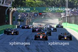 (L to R): Lando Norris (GBR) McLaren MCL60 and Max Verstappen (NLD) Red Bull Racing RB19 lead at the start of Sprint. 04.11.2023. Formula 1 World Championship, Rd 21, Brazilian Grand Prix, Sao Paulo, Brazil, Sprint Day.