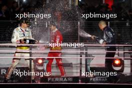 (L to R): Race winner Max Verstappen (NLD) Red Bull Racing celebrates on the podium with third placed team mate Sergio Perez (MEX) Red Bull Racing and Francesco Laus, Red Bull Racing Senior Tyre Simulation Engineer. 18.11.2023. Formula 1 World Championship, Rd 22, Las Vegas Grand Prix, Las Vegas, Nevada, USA, Race Day.