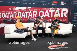 (L to R): Oscar Piastri (AUS) McLaren;  Max Verstappen (NLD) Red Bull Racing; and Lando Norris (GBR) McLaren in the post race FIA Press Conference. 08.10.2023. Formula 1 World Championship, Rd 18, Qatar Grand Prix, Doha, Qatar, Race Day.