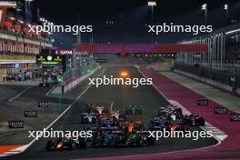 Max Verstappen (NLD) Red Bull Racing RB19 leads George Russell (GBR) Mercedes AMG F1 W14 and Lewis Hamilton (GBR) Mercedes AMG F1 W14, who collided at the start of the race. 08.10.2023. Formula 1 World Championship, Rd 18, Qatar Grand Prix, Doha, Qatar, Race Day.