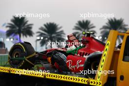 The Ferrari SF-23 of Carlos Sainz Jr (ESP) Ferrari is recovered back to the pits on the back of a truck after he crashed in the second practice session. 24.11.2023. Formula 1 World Championship, Rd 23, Abu Dhabi Grand Prix, Yas Marina Circuit, Abu Dhabi, Practice Day.