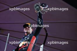 Race winner Max Verstappen (NLD) Red Bull Racing celebrates on the podium. 26.11.2023. Formula 1 World Championship, Rd 23, Abu Dhabi Grand Prix, Yas Marina Circuit, Abu Dhabi, Race Day.