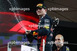 Race winner Max Verstappen (NLD) Red Bull Racing celebrates on the podium. 26.11.2023. Formula 1 World Championship, Rd 23, Abu Dhabi Grand Prix, Yas Marina Circuit, Abu Dhabi, Race Day.