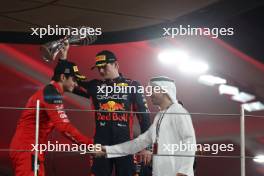 (L to R): Charles Leclerc (MON) Ferrari celebrates his second position on the podium with race winner Max Verstappen (NLD) Red Bull Racing. 26.11.2023. Formula 1 World Championship, Rd 23, Abu Dhabi Grand Prix, Yas Marina Circuit, Abu Dhabi, Race Day.