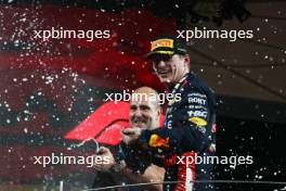Race winner Max Verstappen (NLD) Red Bull Racing celebrates on the podium with Jamie Meades (GBR) Red Bull Racing Head Of Supply Chain Operations. 26.11.2023. Formula 1 World Championship, Rd 23, Abu Dhabi Grand Prix, Yas Marina Circuit, Abu Dhabi, Race Day.
